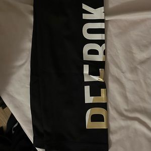 Black Capri/full length leggings with design on clave.